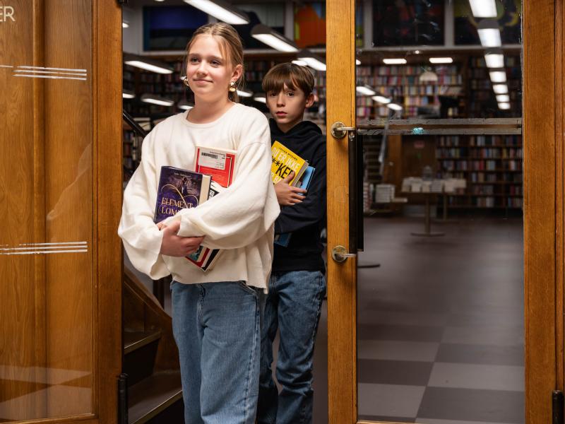 Børn på vej ud af biblioteket med bøger